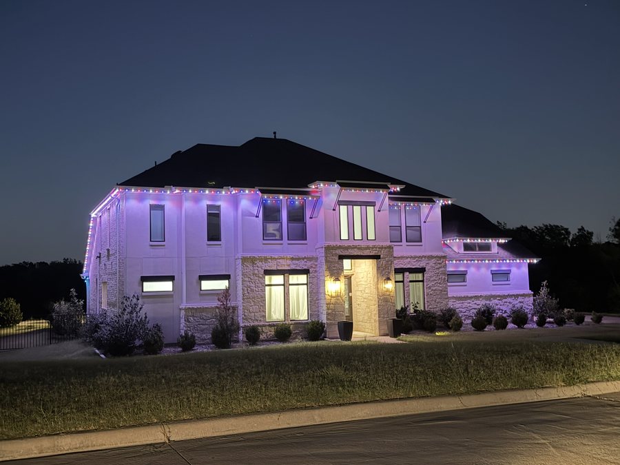 A San Antonio home with permanent color roofline lighting at night