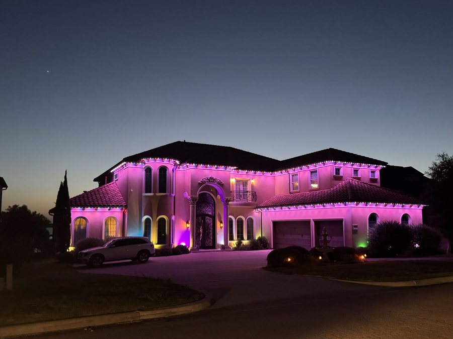 A San Antonio home with permanent color roofline lighting at night