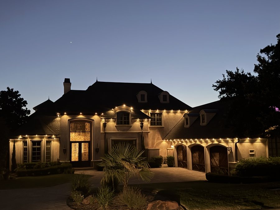 A San Antonio home with warm white permanent roofline lighting at night